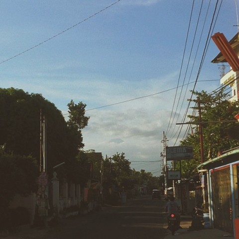 It's a bit hard to make out, but this is the street I live on in Jogja - and in the background, Merapi.